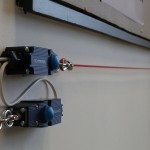 Grab-wire interrupt span along the room walls.